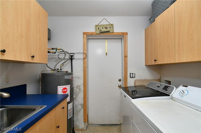 washroom featuring cabinet space, washing machine and clothes dryer, water heater, a sink, and light tile patterned flooring