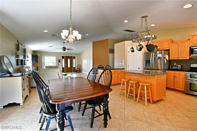 dining area featuring light tile patterned floors, recessed lighting, ceiling fan with notable chandelier, visible vents, and vaulted ceiling