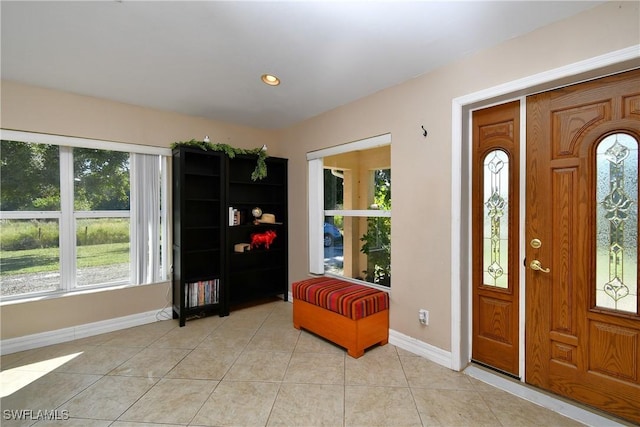 entrance foyer featuring light tile patterned floors, baseboards, and recessed lighting