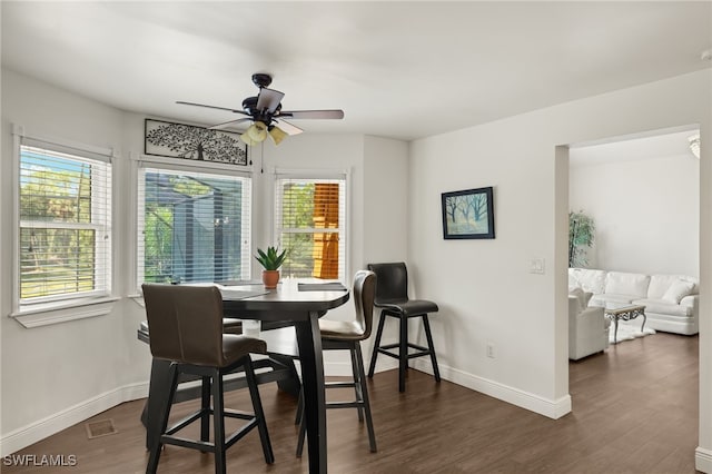 dining room featuring dark hardwood / wood-style floors and ceiling fan