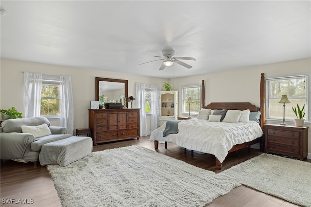 bedroom with ceiling fan, hardwood / wood-style flooring, and multiple windows