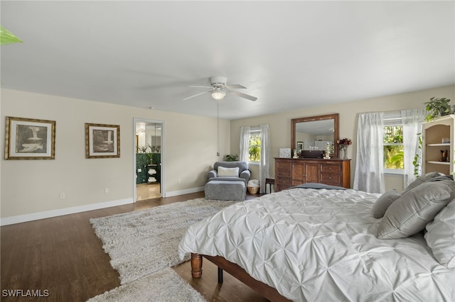 bedroom featuring ceiling fan, wood-type flooring, and multiple windows