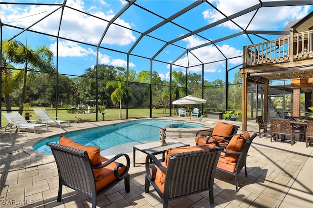 view of pool with an in ground hot tub, a patio area, and glass enclosure