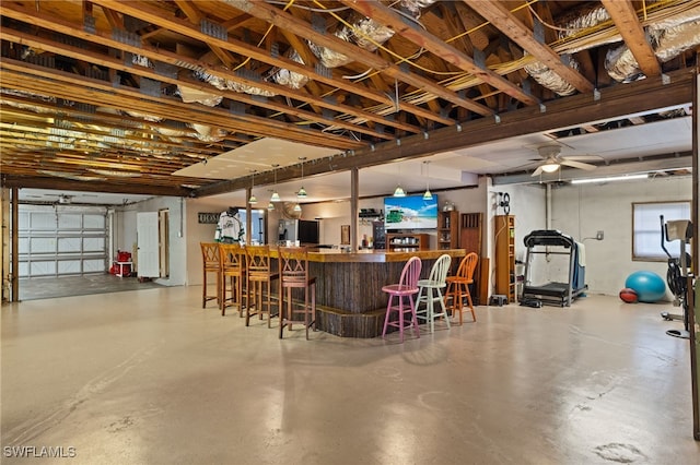 bar with pendant lighting, concrete floors, and ceiling fan