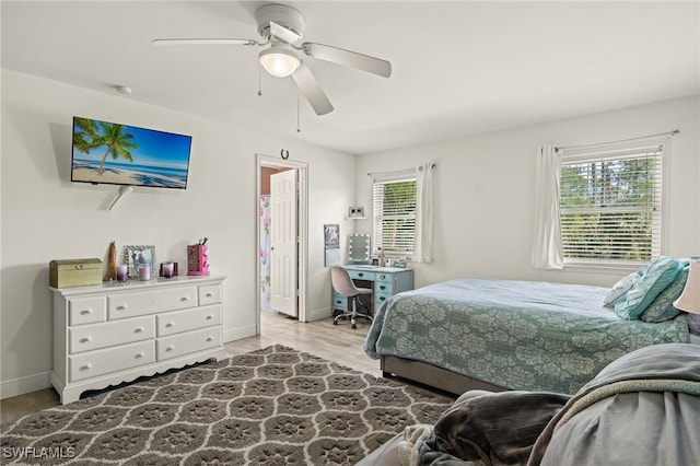 bedroom featuring multiple windows, light wood-type flooring, and ceiling fan