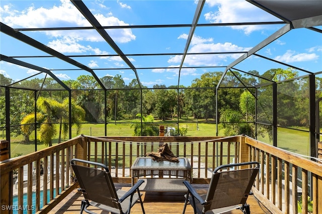 deck featuring a lanai, a yard, and a pool