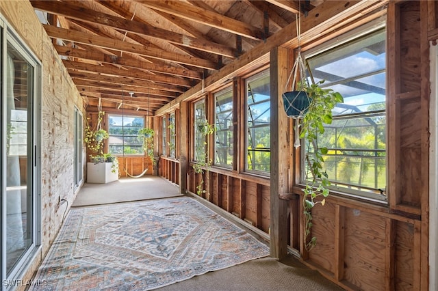 unfurnished sunroom featuring lofted ceiling