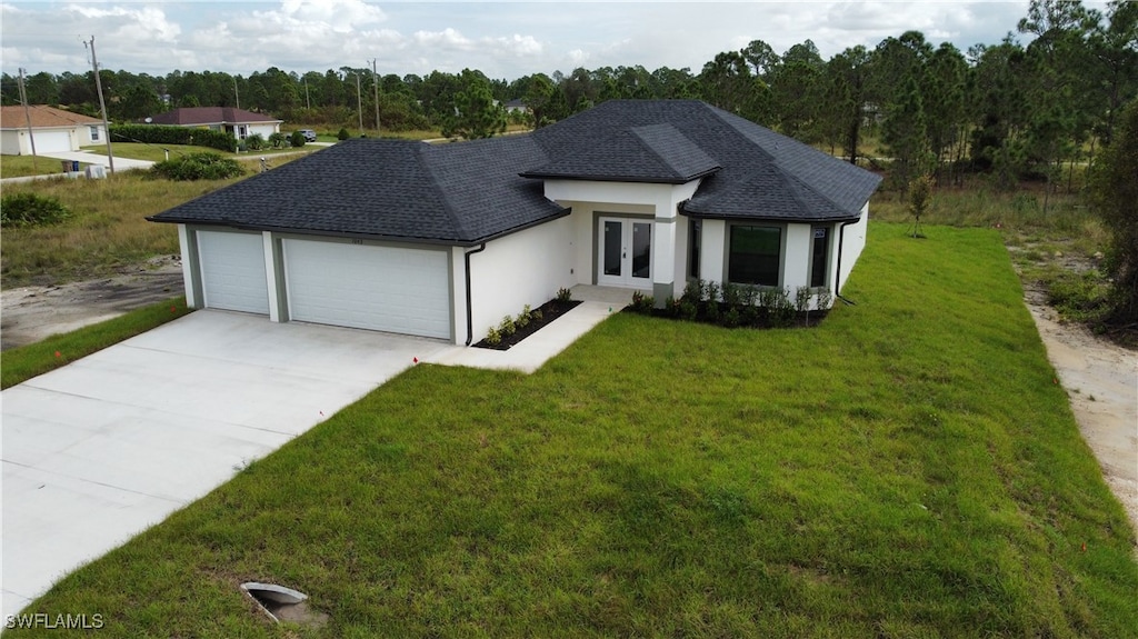 view of front of property with a garage and a front lawn