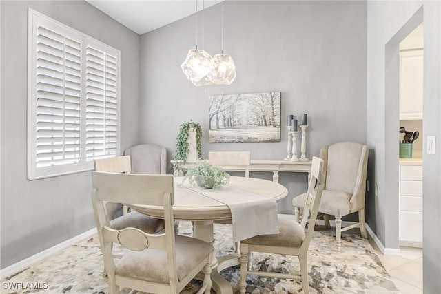 dining space with a chandelier and baseboards