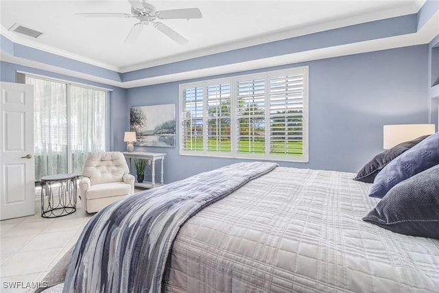 tiled bedroom featuring crown molding, visible vents, multiple windows, and a tray ceiling