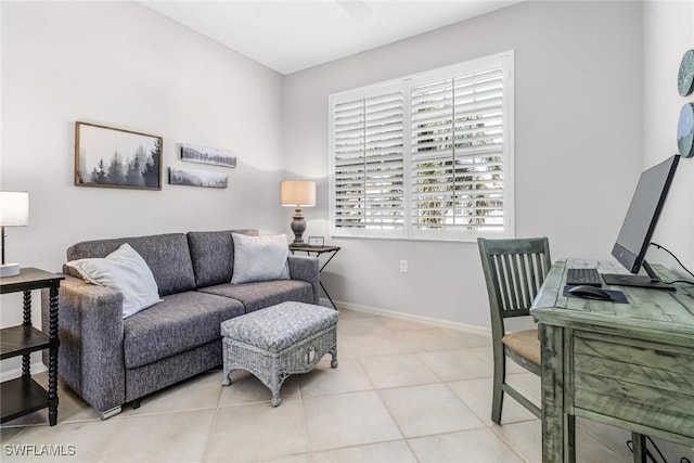 interior space featuring baseboards and ceiling fan
