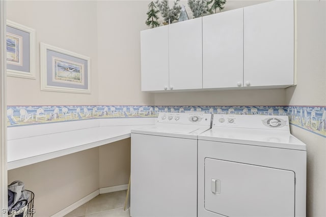 laundry room featuring independent washer and dryer, light tile patterned floors, and cabinets