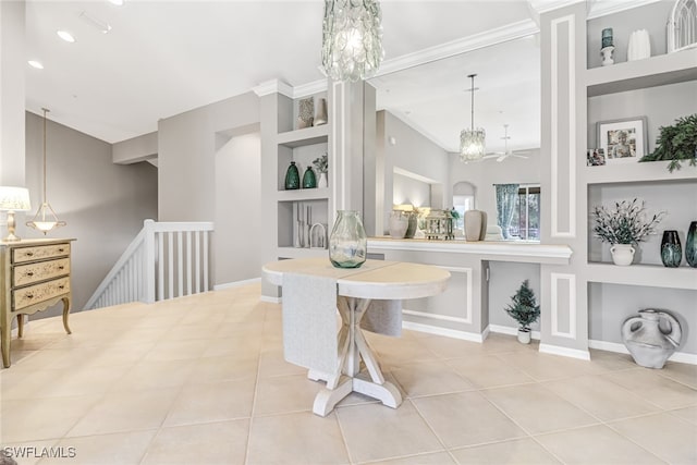 tiled dining space featuring crown molding, a chandelier, and built in shelves