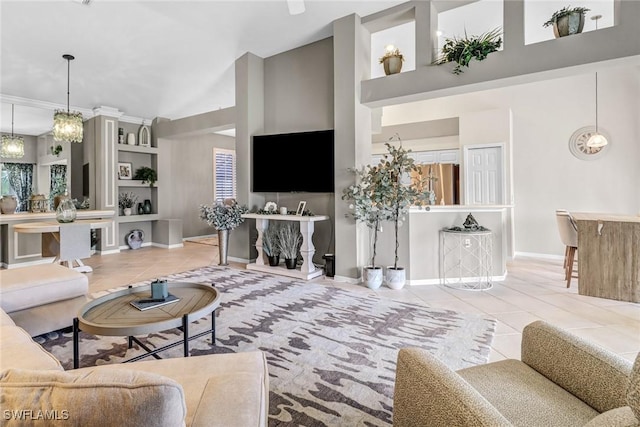 tiled living room featuring a towering ceiling, built in shelves, and baseboards