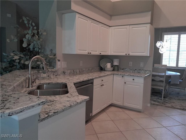 kitchen with light stone countertops, a sink, light tile patterned floors, dishwashing machine, and white cabinetry