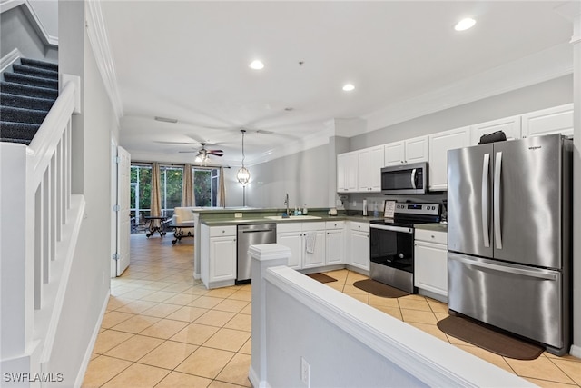 kitchen featuring kitchen peninsula, stainless steel appliances, ornamental molding, white cabinetry, and ceiling fan