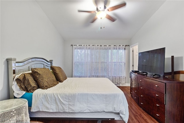 bedroom featuring dark hardwood / wood-style flooring, ceiling fan, and vaulted ceiling