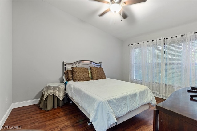 bedroom featuring dark hardwood / wood-style floors, vaulted ceiling, and ceiling fan