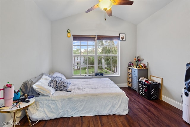 bedroom with ceiling fan, vaulted ceiling, and dark hardwood / wood-style flooring