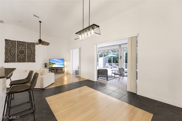 interior space with lofted ceiling, dark hardwood / wood-style floors, and ceiling fan