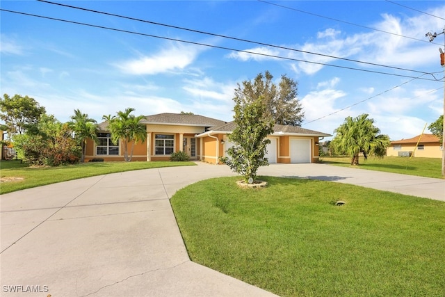 view of front of property with a front yard and a garage