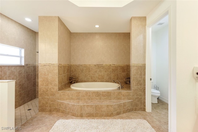 bathroom with toilet, tile walls, tile patterned flooring, and plus walk in shower