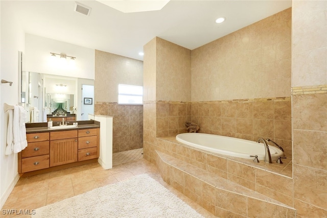 bathroom with vanity, tile walls, shower with separate bathtub, and tile patterned flooring