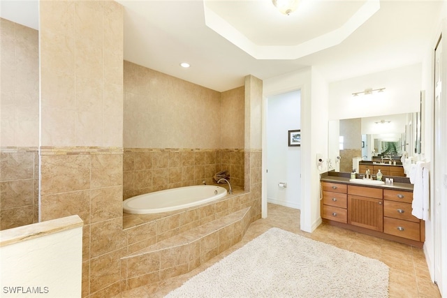 bathroom featuring tile walls, vanity, tiled bath, and tile patterned flooring