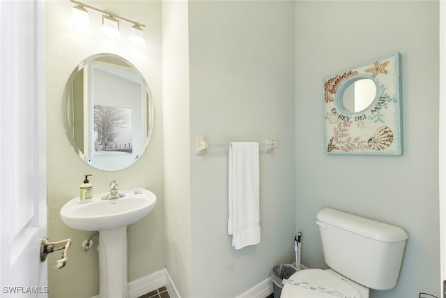 bathroom featuring sink and toilet