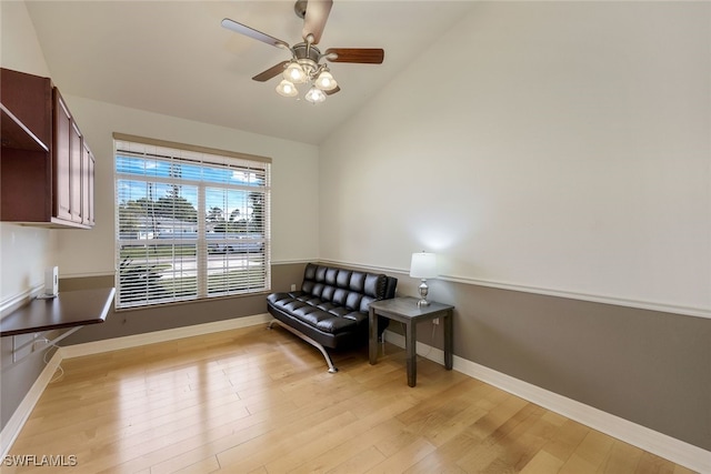 sitting room featuring ceiling fan, vaulted ceiling, and light wood-type flooring