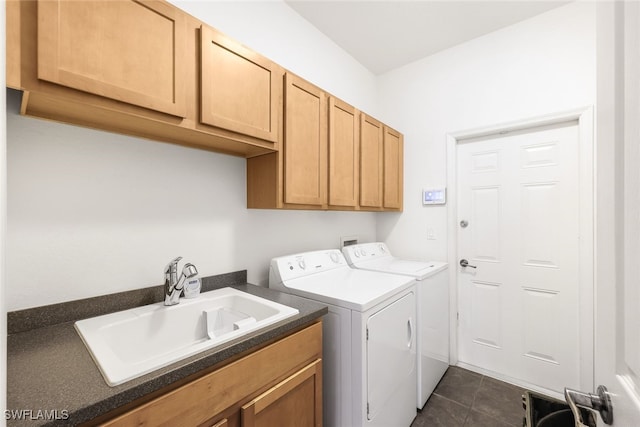 laundry area featuring dark tile patterned floors, sink, independent washer and dryer, and cabinets