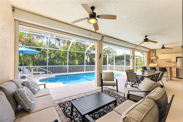 view of swimming pool with an outdoor hangout area, ceiling fan, a patio area, and a lanai