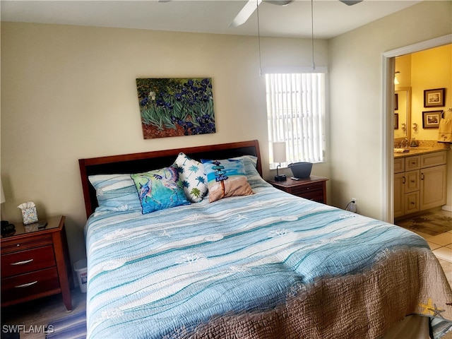 bedroom with connected bathroom, ceiling fan, and light wood-type flooring