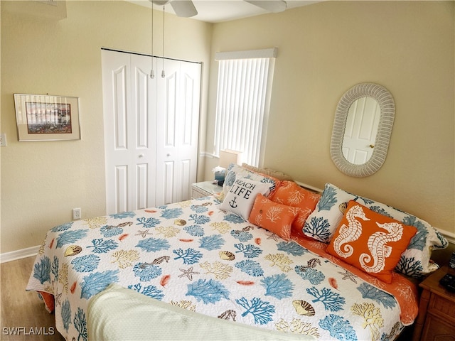 bedroom with a closet, ceiling fan, and hardwood / wood-style flooring