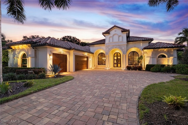 mediterranean / spanish house with french doors and a garage