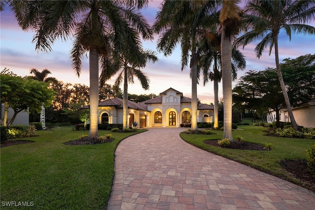 mediterranean / spanish house with a lawn