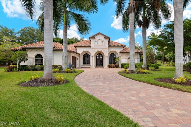 mediterranean / spanish-style house with a front yard