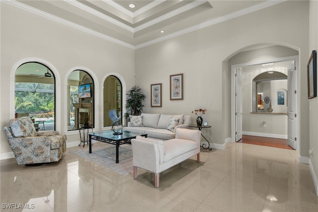 living room featuring ornamental molding and a towering ceiling