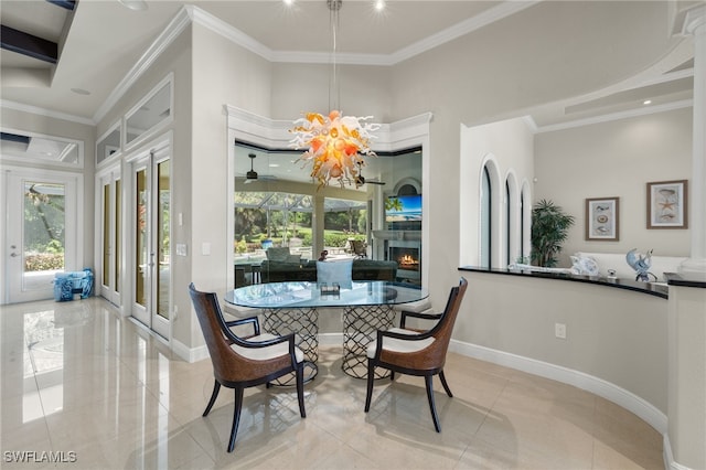 dining space with french doors, ornamental molding, light tile patterned flooring, and an inviting chandelier