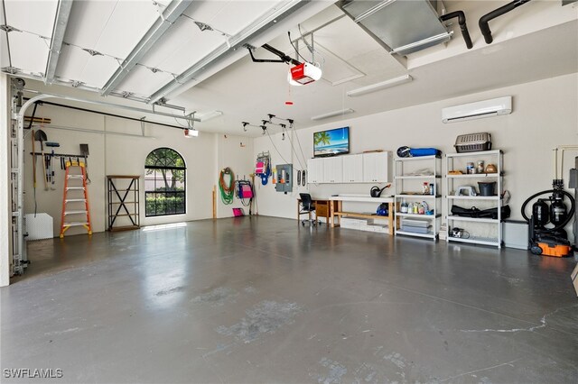 garage featuring a garage door opener, a wall mounted AC, and electric panel