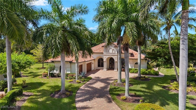 mediterranean / spanish house featuring a front lawn