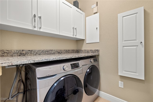 laundry area with cabinets and separate washer and dryer