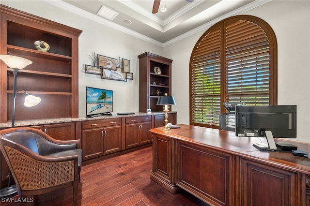 office area with ceiling fan, a raised ceiling, ornamental molding, and dark hardwood / wood-style flooring