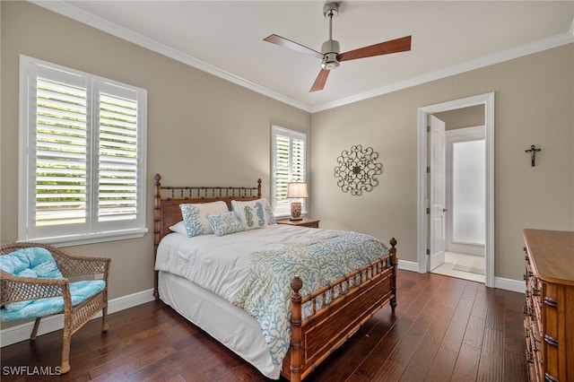 bedroom with ensuite bath, multiple windows, dark hardwood / wood-style floors, and ceiling fan