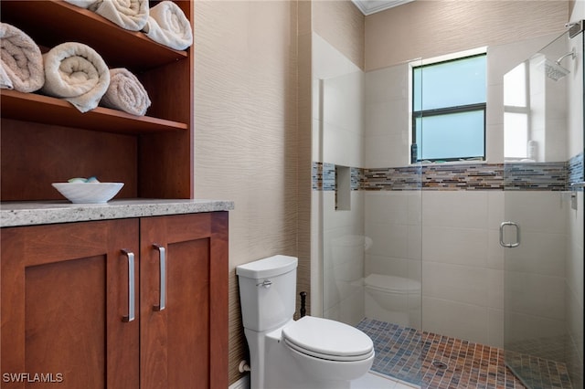 bathroom featuring vanity, toilet, and an enclosed shower