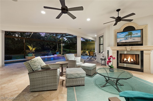 view of patio with glass enclosure, pool water feature, and ceiling fan