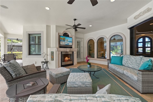 view of patio featuring an outdoor living space with a fireplace and ceiling fan