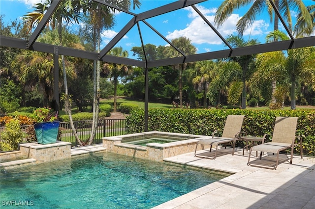 view of pool featuring an in ground hot tub, a patio area, and a lanai