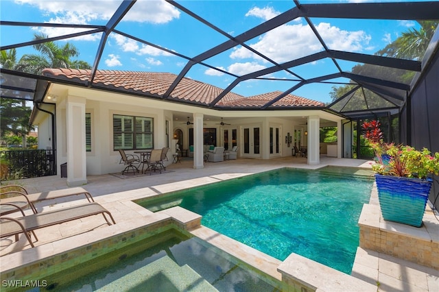 view of pool with a patio, ceiling fan, and glass enclosure