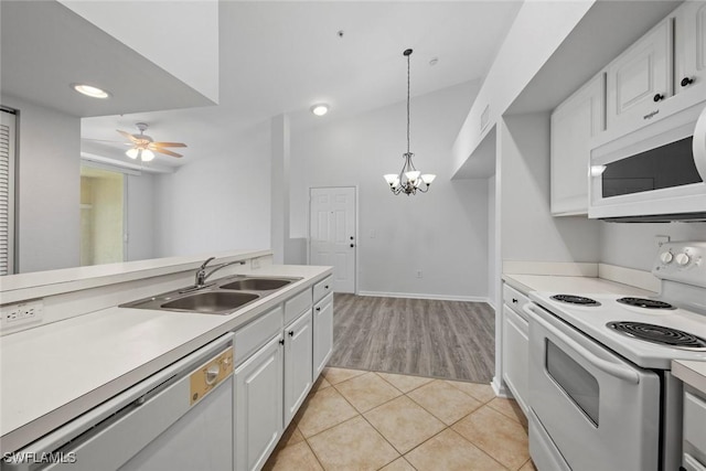 4105 Residence Dr Unit 718, Fort Myers, FL 33901 - kitchen with white appliances, a sink, light countertops, white cabinets, and a chandelier